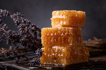 Honey background. Sweet honey comb and lavender flowers close-up.