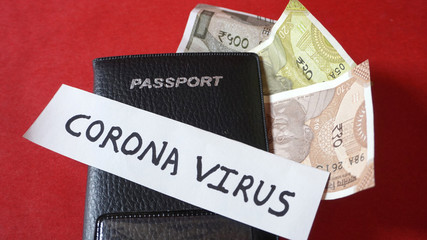 Coronavirus and travel concept. Note COVID-19 /coronavirus, and passport with money.Travel...
