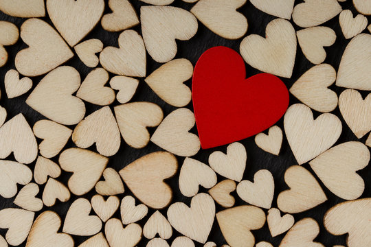one red heart on the Wooden hearts background