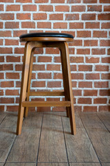 Wooden chair or stool vintage with the old brick wall interior retro style decoration