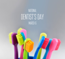 National Dentist's Day images. Colored toothbrushes stock images. Morning hygiene images. Bathroom accessories images. Toothbrush on a silver background. Dentists Day Poster, March 6. Important day
