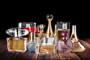 Collection of colored glass perfume bottles on the desk