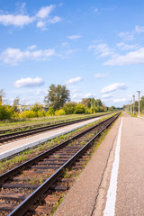 Fototapeta na wymiar Railroad tracks and platform in the countryside