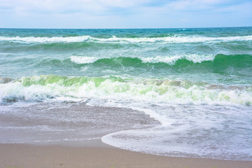 waves crash on sandy beach