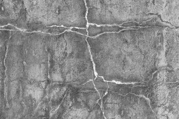 Gray concrete wall with cracks
