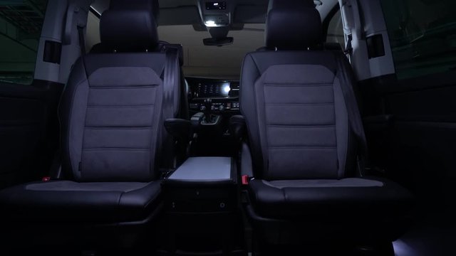 Luxury leather seats in the comfortable van. Interior of luxury minivan with backlight, transfer car