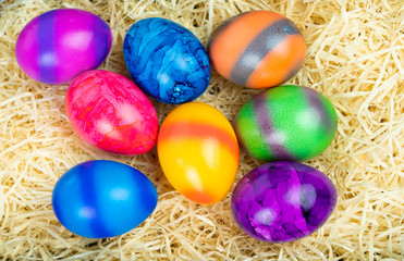 Fototapeta na wymiar Easter basket with colorful Easter eggs, view from above