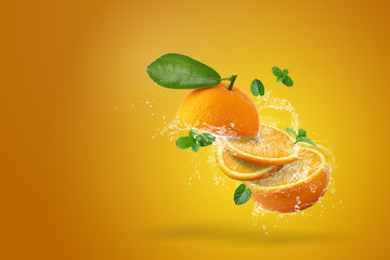 Water splashing on Fresh Sliced ​​oranges fruit on Orange background