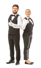 Male and female waiters showing thumb-up on white background