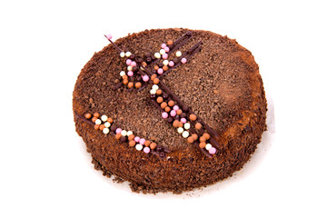 Chocolate cake with chocolate ship topping isolated on white background.