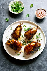 Roasted quails on white plate