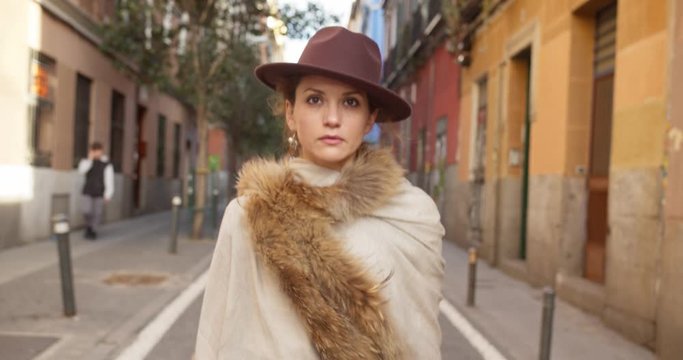 confident strong independent girl woman lady in retro walks the street serious