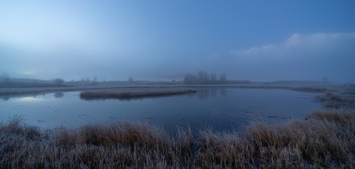 Foggy morning on a mountain lake