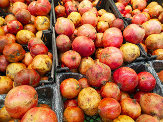 Ripe pomegranates on a shelf in a store