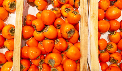 Ripe persimmons on a shelf in a store