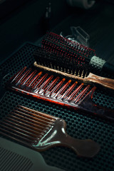 Hairbrushes in a barber shop on a black table. Hair styling. Professional barber tools.