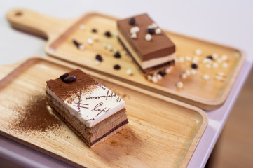 chocolate cake on wooden plate in mini cafe