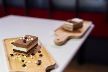 chocolate cake on wooden plate in mini cafe