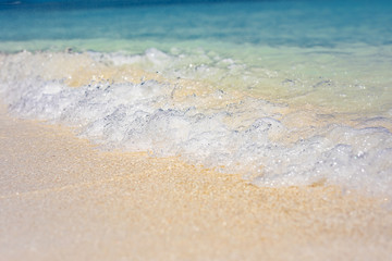 Wave of the sea on the sand beach. Tropical shore, waves splashing