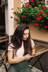 Obraz na płótnie Canvas Beautiful woman using tablet sitting in street cafe.