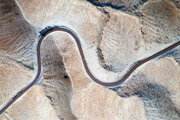 Curvy road in Nevada desert from above. Texture / background theme.