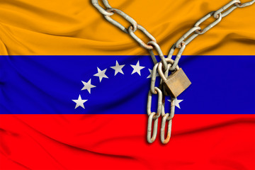 iron chain and lock on the silk national flag of Venezuela with beautiful folds, the concept of a...
