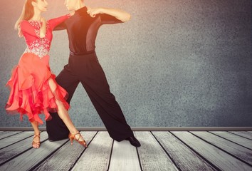 Man and a woman dancing Salsa on floor