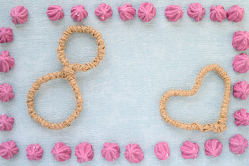 Happy Women's Day. Background for Women's Day. Greeting card international women's day March 8. frame from pink marshmallow heart and the number eight lie on paper background
