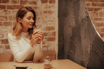 Young Woman with Cup of Coffee. Cup of Coffee in the hands. girl enjoys her morning fragrant coffee...
