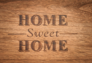 Home sweet home sign on a wood background