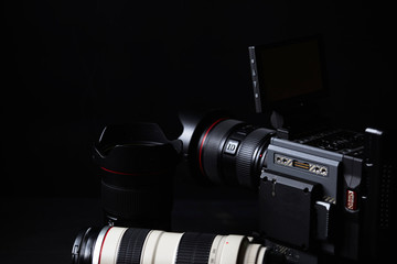 Cinema Camera, with high quality lens, isolated on black with dramatic light