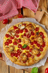 Savoury pastry quiche with cottage cheese, cherry tomatoes and goat cheese