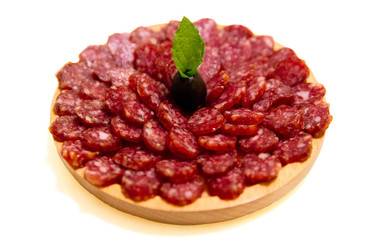 Antipasto platter salami and cheese platter on wooden board over white background. Appetizer, catering food concept