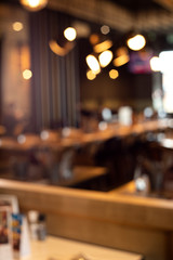 Blur light gold bokeh of cafe restaurant in dark background