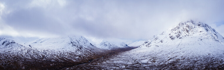 aerial drone shot of rannoch moor and the entrance to glencoe in winter with Lochan na h-Achlaise during march
