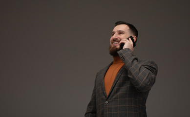 Business and phone talk concept. Man in formal suit has phone conversation. Businessman with happy...