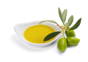 Small bowl with olive oil anf green olives.