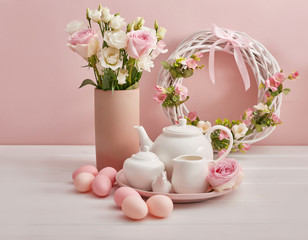 Easter table setting with cake,eggs and flowers. Happy Easter Greeting Card Template. Easter cake and colorful eggs on festive table. The concept of family celebration. Easter holiday.