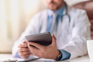 Doctor at hospital working with tablet