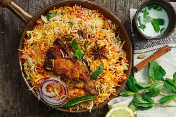Homemade Fish Biryani served with yogurt Raita Salad, selective focus