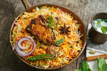 Homemade Fish Biryani served with yogurt Raita Salad, selective focus