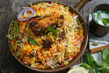 Homemade Fish Biryani served with yogurt Raita Salad, selective focus