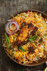 Homemade Fish Biryani served with yogurt Raita Salad, selective focus