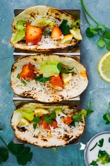 Homemade Chicken Tikka Tacos served in a metal Taco stand, selective focus