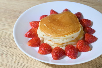 pancake and strawberry fruit sweet dessert food put on breakfast table