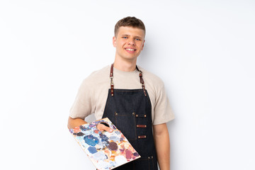 Young handsome man over isolated white background holding a palette