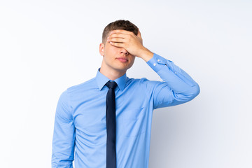 Young handsome businessman covering eyes by hands