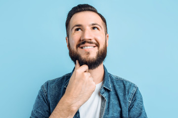 Fototapeta premium Pensive man on a blue background