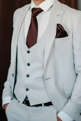 Man in suit, vest, tie. close-up. Perfect to the last detail. Modern businessman. Fashion shot of a handsome young man in elegant classic suit.