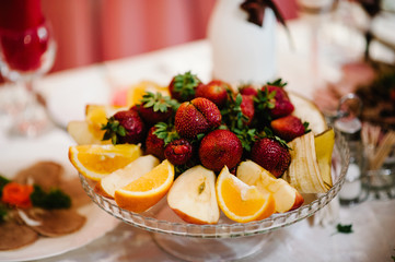 Fresh, exotic, organic fruits, light snacks in a plate on a buffet table. Assorted mini delicacies and snacks, restaurant food at event. Decorated delicious table for a party goodies.
